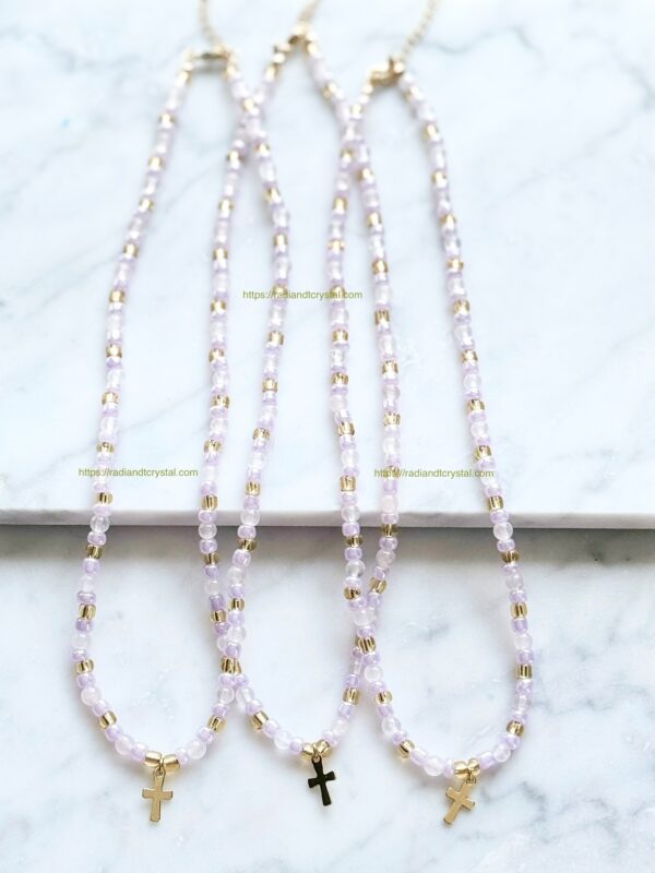 Three beaded necklaces with gold crosses.