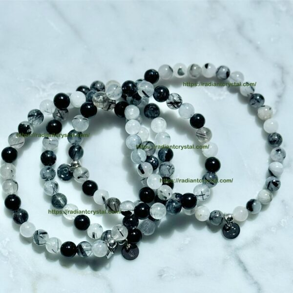 Black and white beaded bracelets on marble.