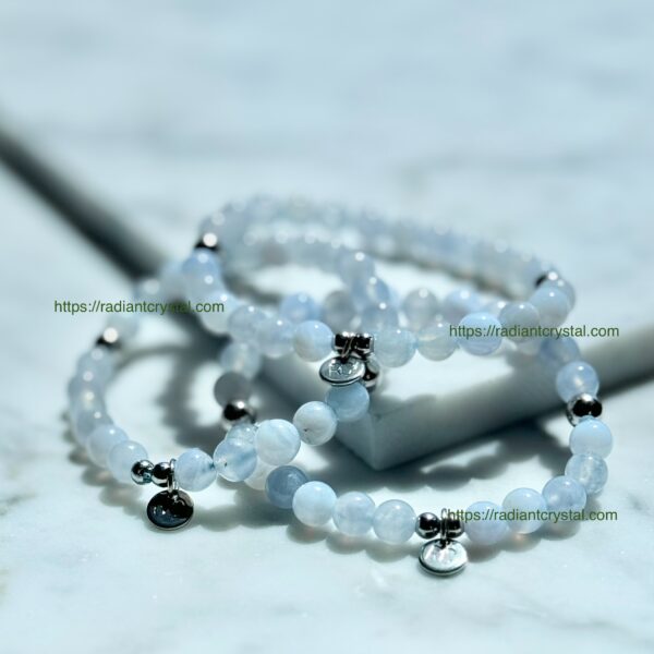 Blue gemstone bead bracelets with charms.