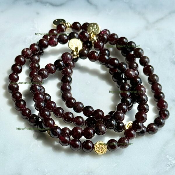 Garnet bead bracelets with gold charms.