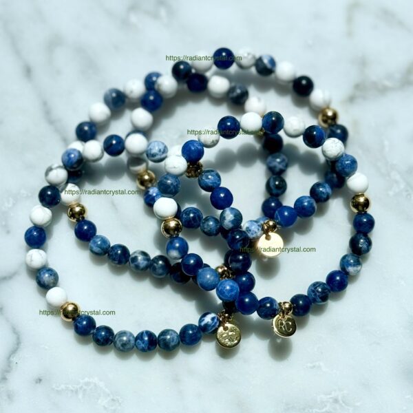 Blue and white beaded bracelets with gold charms.