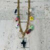 Gold chain necklace with colorful charms.