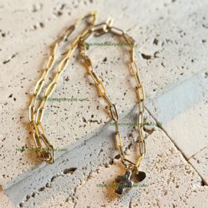 Gold paperclip chain necklace with cross.