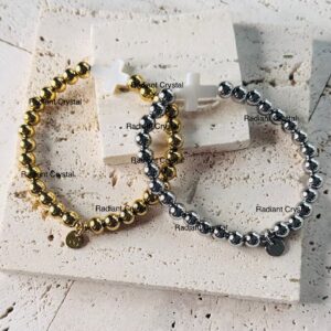 Gold and silver beaded cross bracelets.