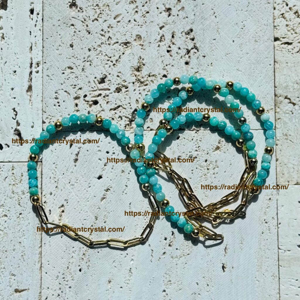 Turquoise and gold beaded bracelets on stone.