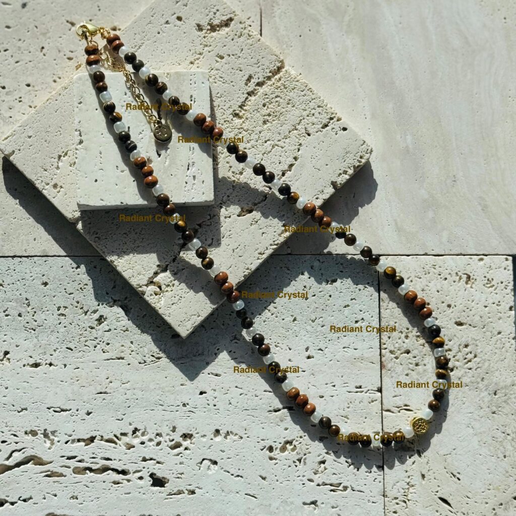 Beaded necklace on textured stone surface.